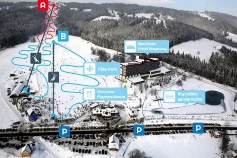 Widok na zakopane stok narciarski z trasami, wyciągami, hotelem Bachleda, karczmą i basenem geotermalnym.