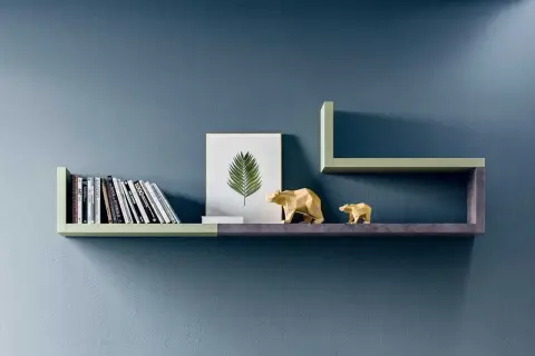 Mensole moderne con libri, un quadro di foglia e orsetti dorati, perfette per fissare mensole al muro con stile.