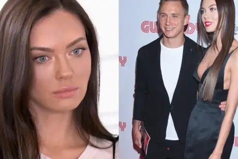 Edyta Zając Rzeźniczak w ciąży, uśmiechnięta z partnerem na ściance.