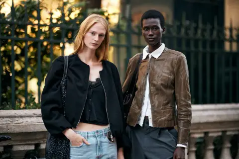 Dwie modelki prezentują stylizacje, w tym kurtkę skórzaną, która może być inspirowana niemieckie marki.