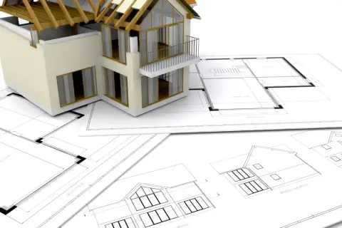 Model domu na planach architektonicznych. Zastanawiasz się, ile trwa budowa domu? To zależy od wielu czynników, ale projekt to pierwszy krok.