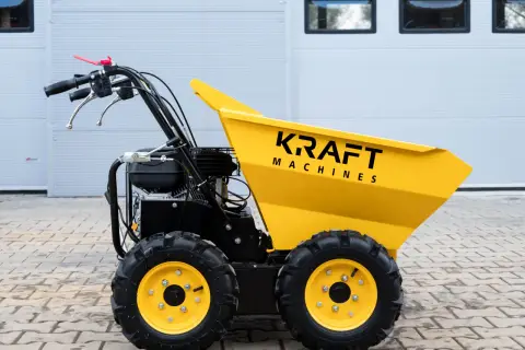 Żółty wozidło taczka spalinowa Kraft Machines z czarnymi kołami i silnikiem, gotowe do pracy na budowie.