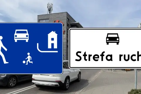 Znaki drogowe informują o wjeździe do strefy ruchu. Na niebieskim znaku widać pieszego, dziecko grające w piłkę i dom.