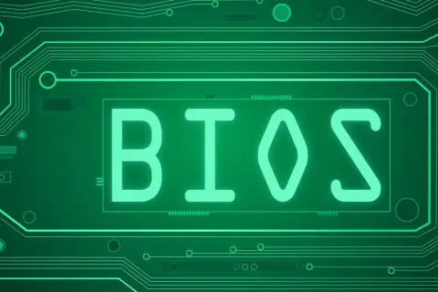 Zielony obwód drukowany z napisem BIOS. Dowiedz się, jak zaktualizować BIOS, aby Twój komputer działał sprawniej.
