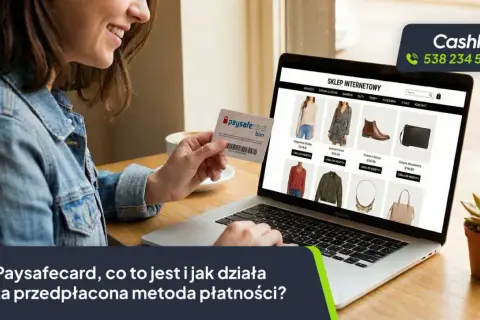 Kobieta trzyma kartę Paysafecard przed ekranem laptopa z otwartym sklepem internetowym.