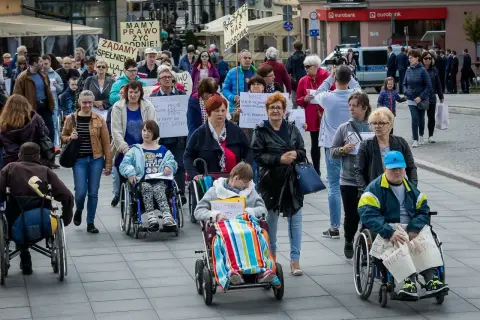 Protest osób na wózkach inwalidzkich. Pytanie: czy dodatek pielęgnacyjny wlicza się do 500 plus dla niepełnosprawnych?