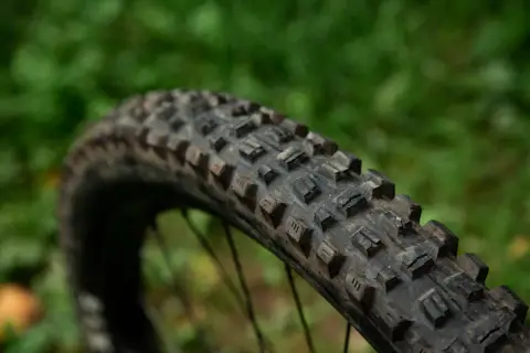 Close-up of a Maxxis Assegai tire, showing its aggressive tread pattern. This tire is ready for any trail.