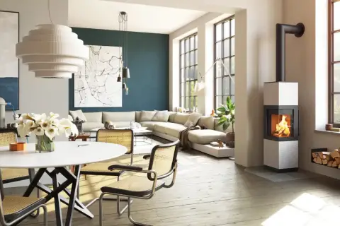 Poêle à bois moderne dans un salon lumineux avec canapé et table à manger.