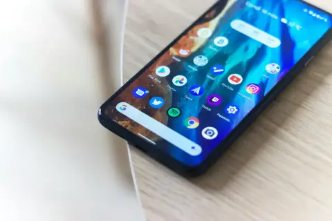 Smartfon z ikonami aplikacji, w tym Play Store. Użytkownik napotkał sklep play błąd serwera, co uniemożliwia pobieranie.