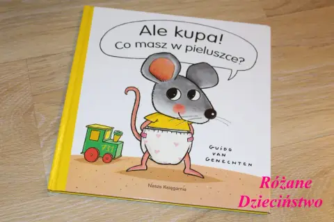Okładka książki "Ale kupa! Co masz w pieluszce?" z myszką w pieluszce i pociągiem.