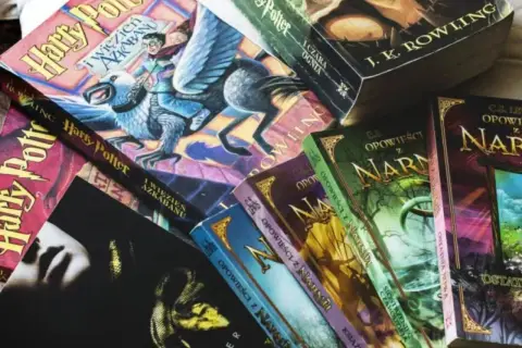 Książki Harry Potter po kolei, obok nich Opowieści z Narnii.