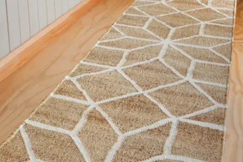 A natural fiber hallway runner with a geometric pattern. This image prompts the question: how long should a hallway runner be to perfectly fit your space?