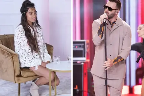 Grzegorz Hyży, król nocy, na scenie. Obok siedząca kobieta w białym swetrze.