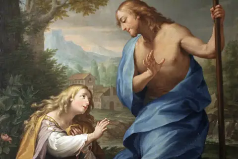 Św. Magdalena, patronka pokutujących, klęczy przed Chrystusem w ogrodzie.