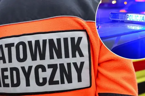Ratownik medyczny w pomarańczowej kurtce, obok policyjny kogut kierunkowy 25.