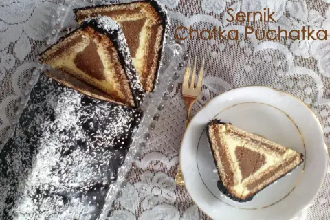Sernik Chatka Puchatka, udekorowany wiórkami kokosowymi, wygląda jak domek Baby Jagi.