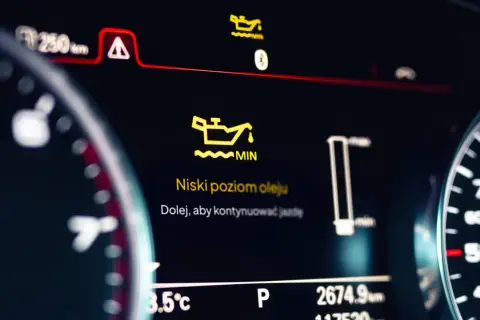 Na desce rozdzielczej świeci się żółta kontrolka wymiany oleju z napisem "Niski poziom oleju". Dolej, aby kontynuować jazdę.