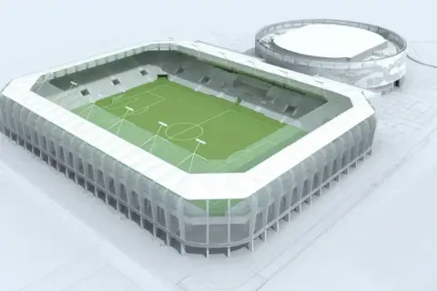 Nowoczesny stadion Radomiaka z zieloną murawą i wielopoziomowymi sektorami. Obok obiekt treningowy.