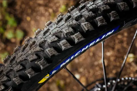 Close-up of a rugged Michelin Force AM2 tire, ready to grip the trail.