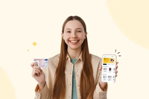 Uśmiechnięta dziewczyna trzyma dowód osobisty i telefon z aplikacją photoAiD. Zastanawiasz się, ile zdjęć do dowodu potrzebujesz?