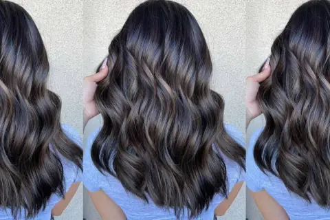Cabello castaño oscuro con reflejos cenizos y ondas suaves.
