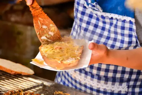 Smaczna kanapka z kapustą i smalcem, choć może podnosić cholesterol, kusi z drewnianej łopatki.