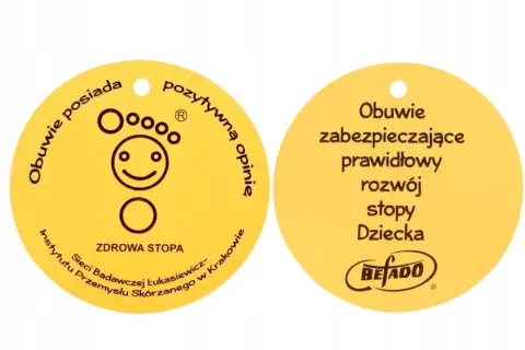 Żółty certyfikat "Zdrowa Stopa" z symbolem uśmiechniętej stopy i napisem "Obuwie zabezpieczające prawidłowy rozwój stopy Dziecka".