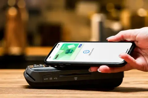 Zbliżanie telefonu do terminala płatniczego. Płatność zbliżeniowa PayPo Visa, bez prowizji od płatności kartą.