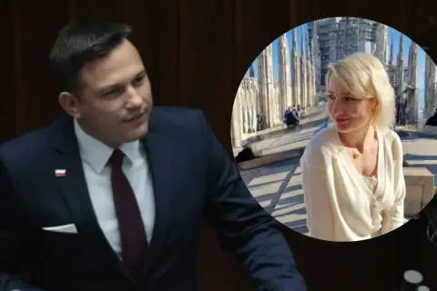 Sławomir Mentzen w garniturze i jego żona uśmiechają się na tle katedry.