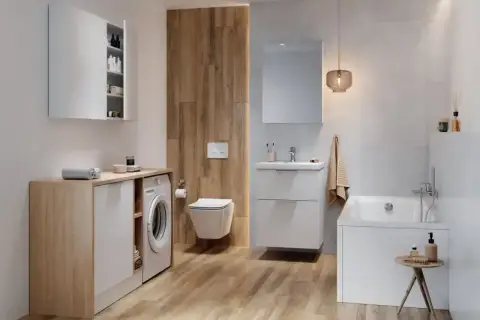Nowoczesna łazienka z pralką, wanną i podwieszanym WC. Widoczny z tyłu złącze WC harmonijkowe.