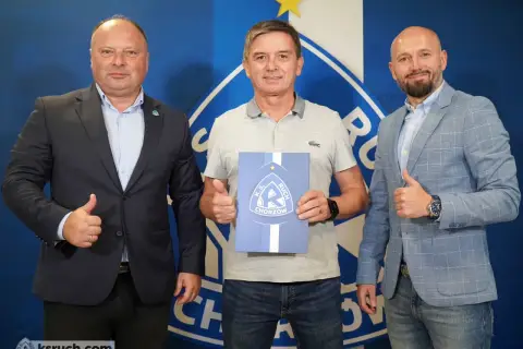Trzech mężczyzn pozuje do zdjęcia z dokumentem K.S. Ruch Chorzów. Jeden z nich, nowy trener ruchu chorzów, trzyma dokument.