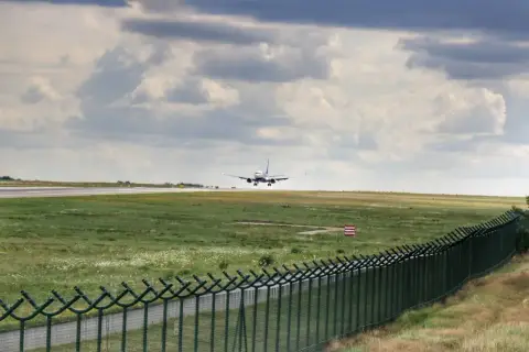 Samolot ląduje na pasie startowym. Widok z tarasu widokowego lotnisko Gdańsk.