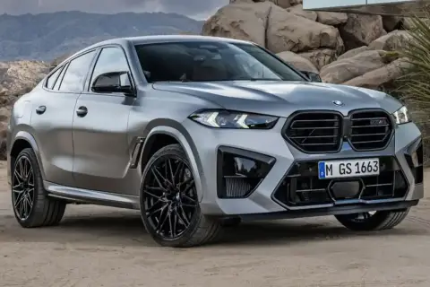 Srebrne x6 BMW z czarnymi felgami na tle skalistego krajobrazu.