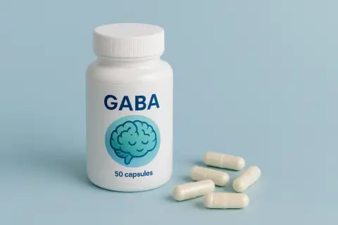 Biała butelka z napisem GABA i grafiką mózgu, obok kilka kapsułek. Zastanawiasz się gaba co to?