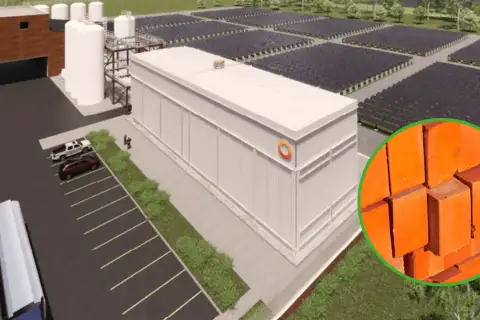 Nowoczesny magazyn energii z piasku, otoczony panelami słonecznymi. W tle cegły, symbolizujące budulec.