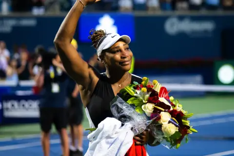 Serena Williams, jedna z legendarnych sióstr Williams, odbiera bukiet kwiatów po meczu.