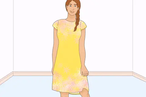 A woman in a yellow floral dress, ready to learn how to line a dress.