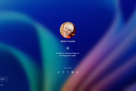 Ekran logowania Windows Hello z uśmiechniętą Robin Counts. Zeskanuj palec, by się zalogować.