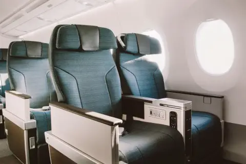 Asientos de business class en un avión, con espacio amplio y detalles de lujo.