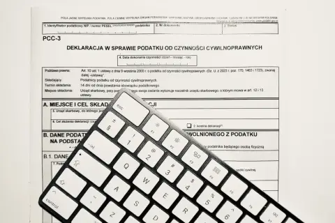 Formularz PCC-3 i klawiatura. Wpisz "podatek od nieruchomości" w tytule przelewu, aby poprawnie opłacić należność.