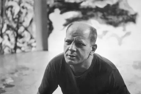 A close-up of Jackson Pollock's face, his brow furrowed in thought, as if contemplating his next drip painting.
