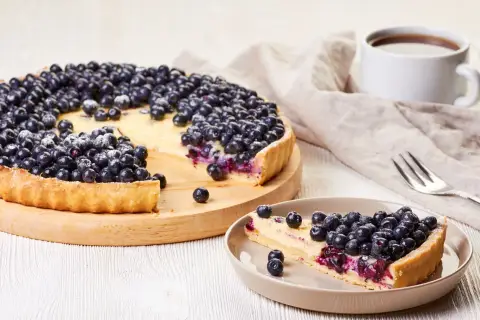 Tarta z owocami i budyniem Ani. Pyszna, domowa tarta z jagodami i kremowym budyniem, posypana cukrem pudrem. Idealna na deser.