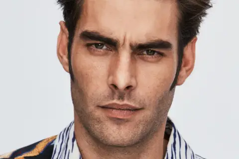 Primer plano de Jon Kortajarena con mirada intensa y camisa estampada.
