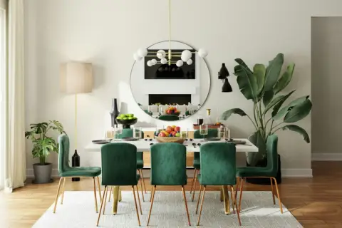 Salle à manger moderne avec six chaises en velours vert émeraude et une table blanche, parfaite pour une dimension salle à manger 8 personnes.