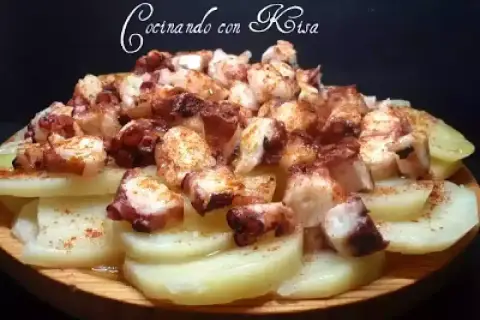 Pulpo con cachelos, un plato gallego tradicional, con trozos de pulpo tierno y patatas cocidas, espolvoreado con pimentón.