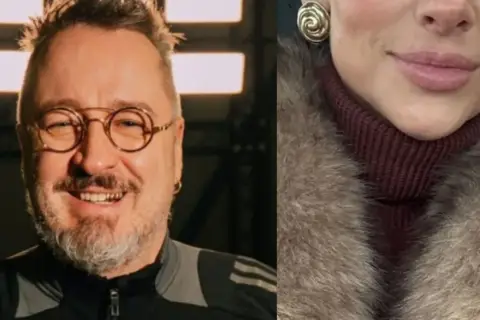 Piotr Kędzierski z żoną, uśmiechnięty mężczyzna w okularach i fragment twarzy kobiety w futrze.
