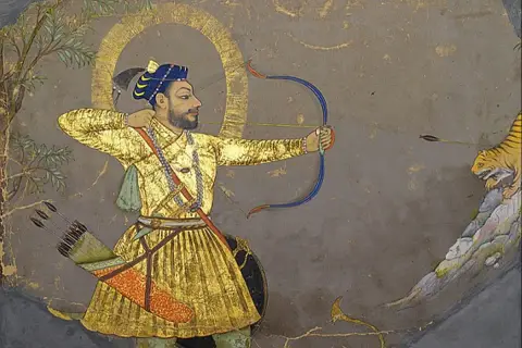 A Mughal miniature painting depicts a man in a golden robe aiming a bow and arrow at a tiger.