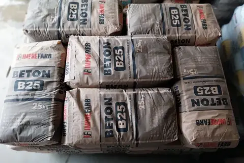 Sztaple worków z betonem B25, każdy po 25 kg. Informacja o tym, ile cementu na kubik betonu, jest zawarta w specyfikacji produktu.