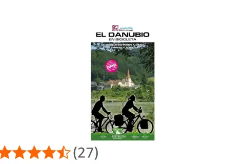 Ruta en bici por el Danubio, de Alemania a Austria. Paisaje fluvial con ciclistas y un pueblo con iglesia.