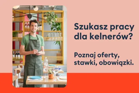 Uśmiechnięty kelner w fartuchu stoi w restauracji, gotowy przyjąć zamówienie. Szukasz pracy dla kelnerów?